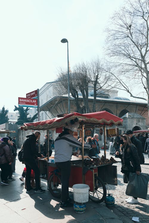 People Buying from Street Stall on City Square