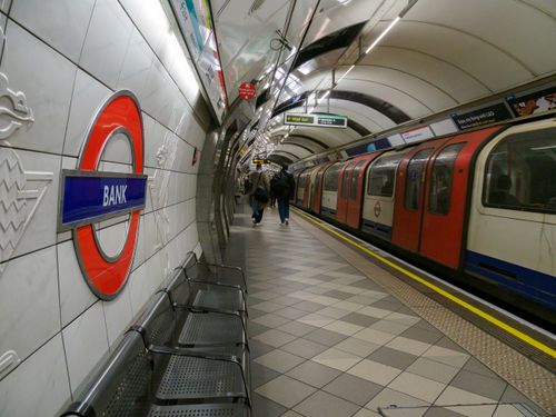 Free View of the Bank Station platform in the London Underground with a train and passengers. Stock Photo