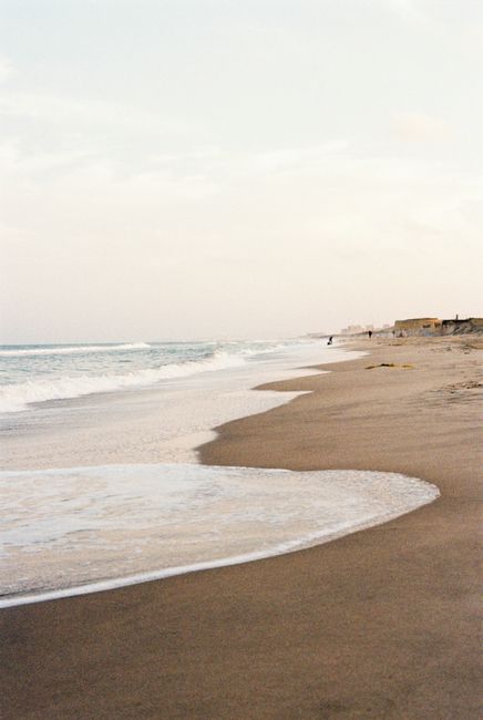 Serene beach with soft waves and a calming horizon, perfect for peaceful moments.
