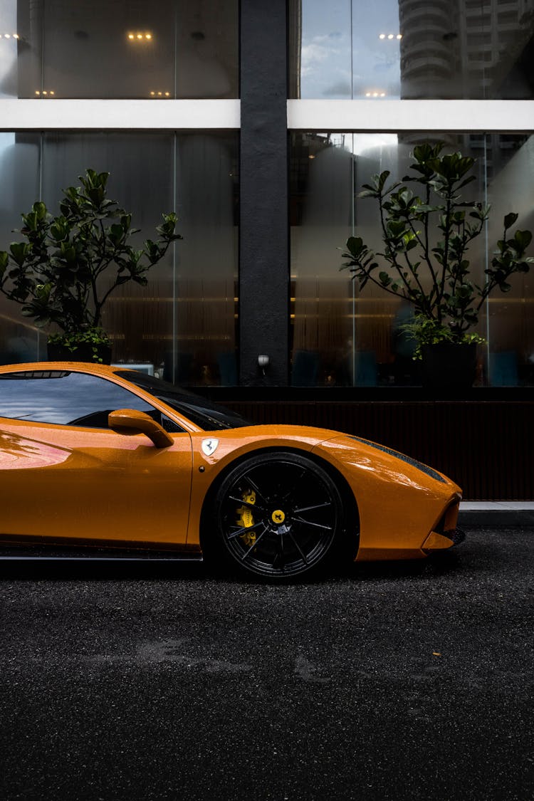 Yellow Ferrari Parked In An Asphalt Road 