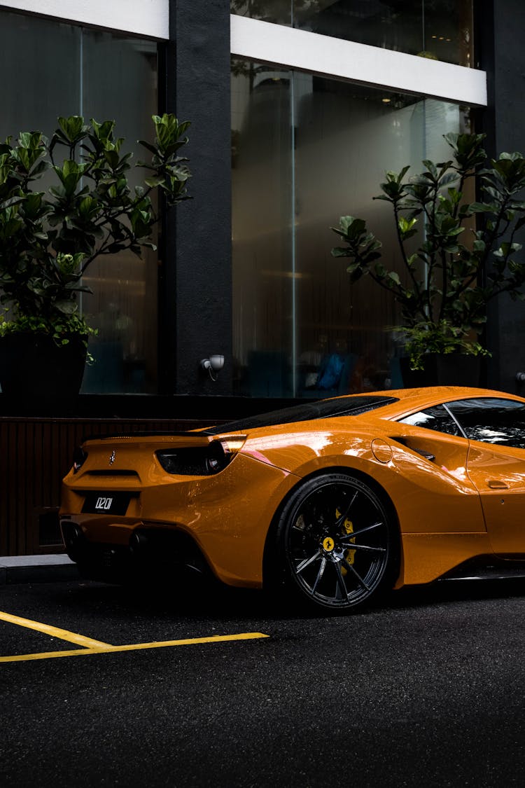 An Orange Luxury Car Parked On The Street