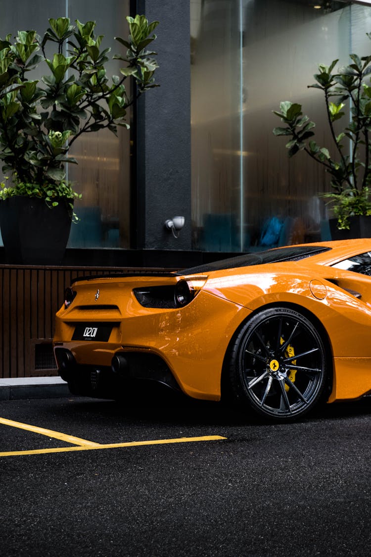 An Orange Luxury Car Parked On The Street