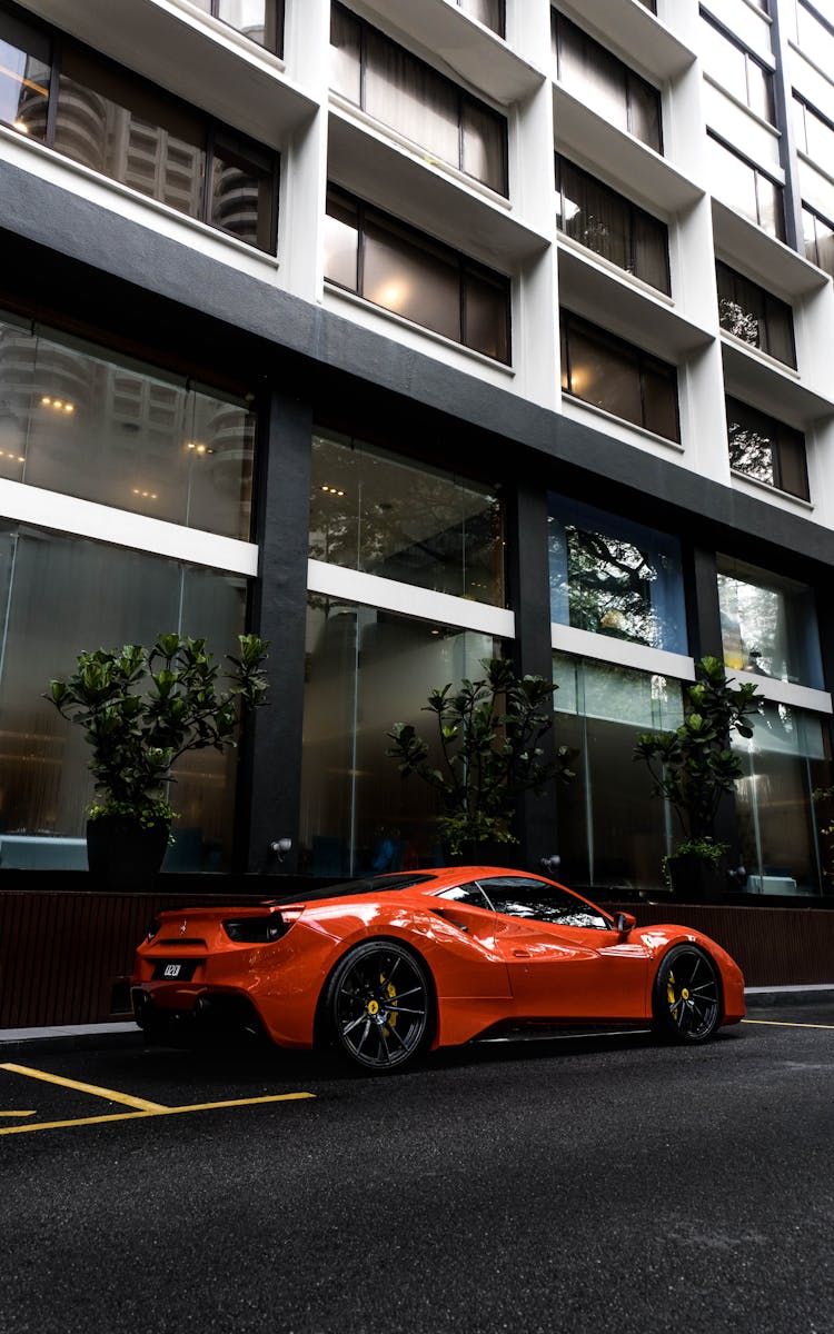 Luxury Car Parked In Front Of An Apartment Building