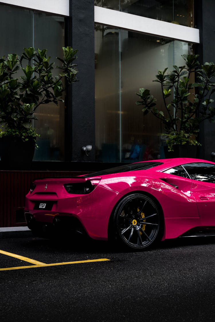 A Pink Luxury Car Parked On The Street