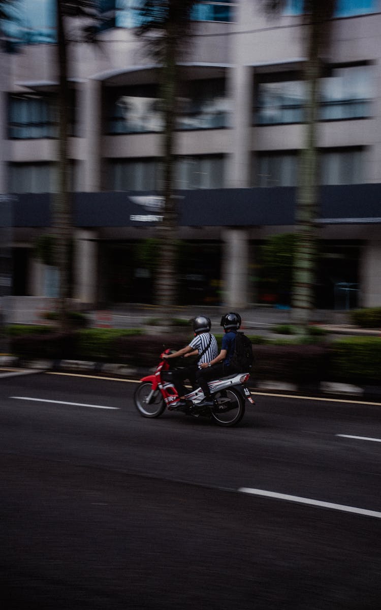 Men Riding Motorbike On City Street