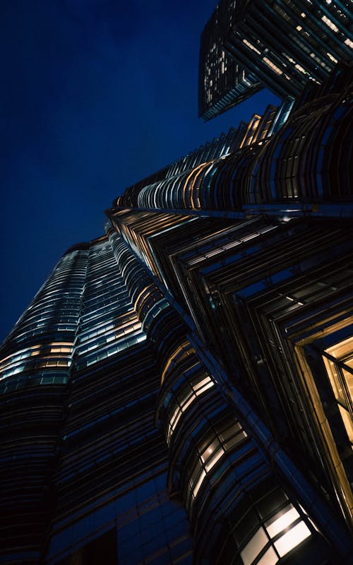 Low Angle Shot of an Illuminated Skyscraper in City at Night 