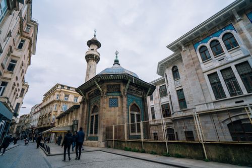Free Street view of Hobyar Mosque with surrounding buildings in Istanbul, Turkey, capturing everyday life. Stock Photo