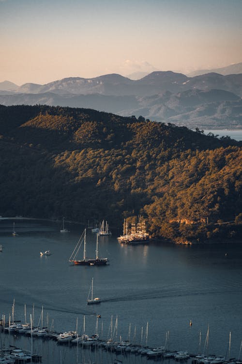 Aerial View of Boats on Lake near Mountain