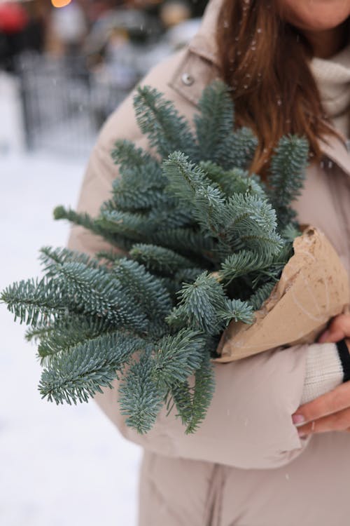 Photo of a Woman Holding an Advent Wreath