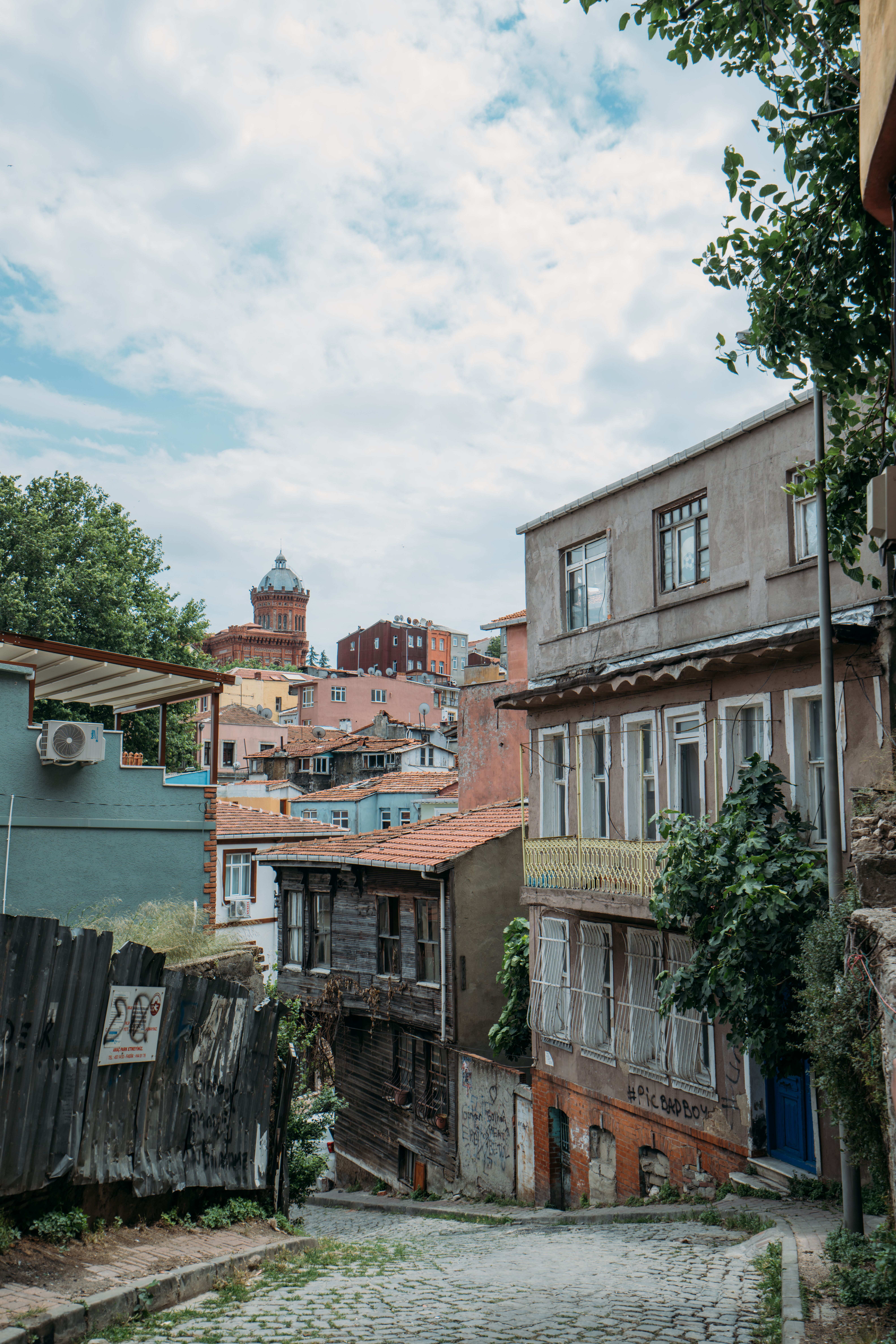 Cobblestone Street in Between Concrete Buildings · Free Stock Photo