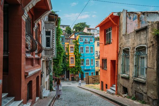 Vibrant urban street featuring historic colorful buildings and people walking.