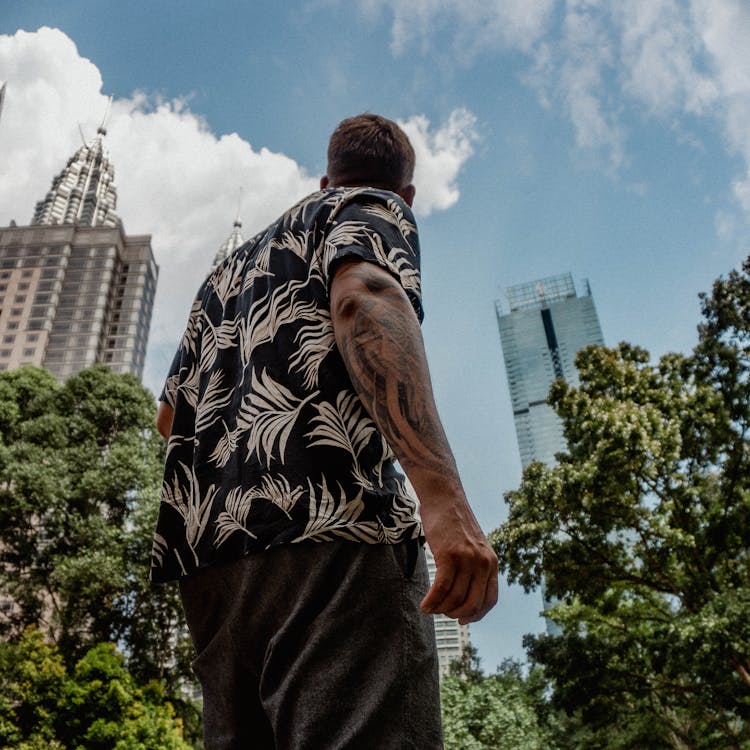 Low-Angle Shot Of A Man With An Arm Tattoo