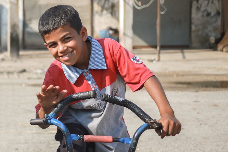 Smiling Boy Riding Bike