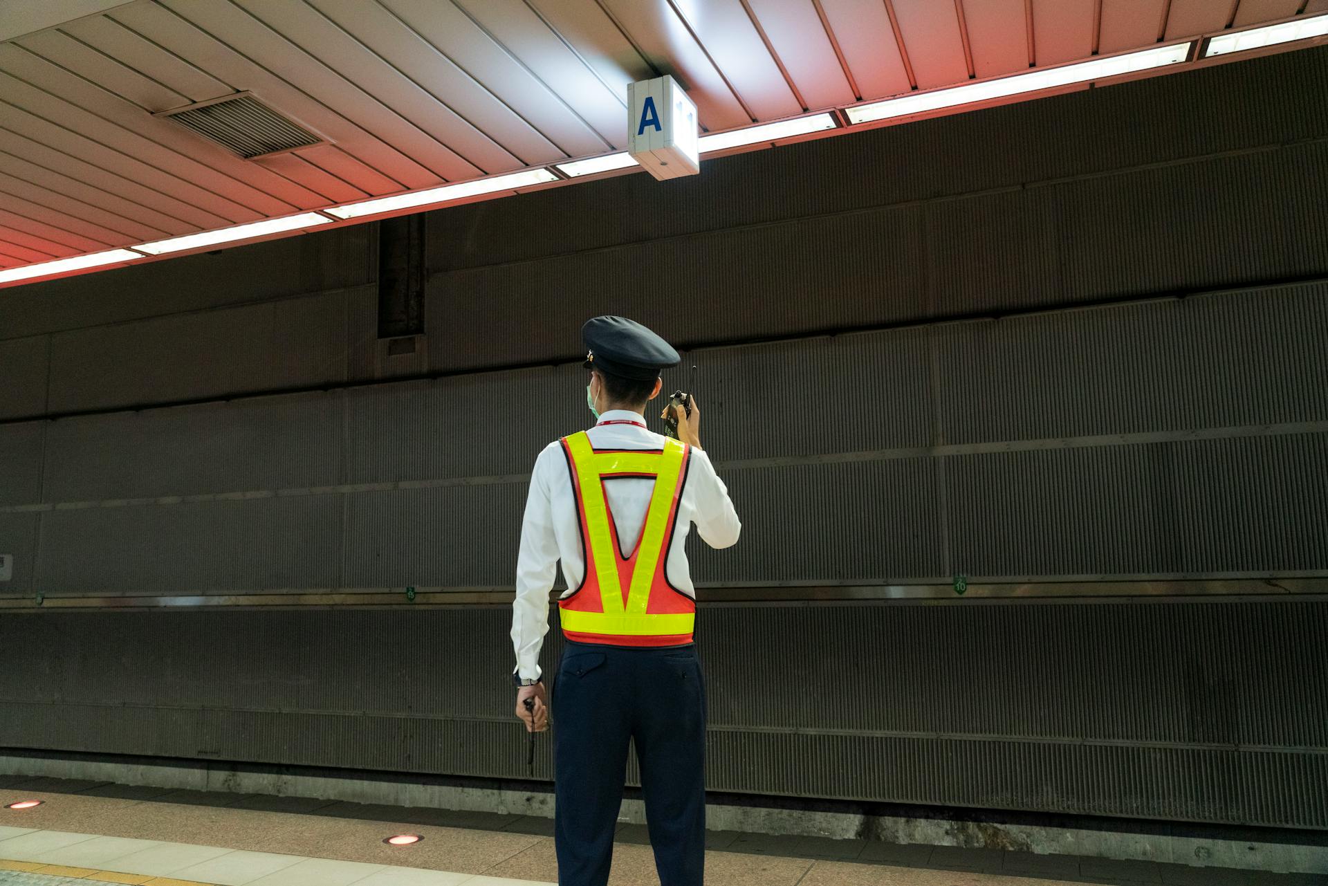 Back View of a Security Guard using Radio