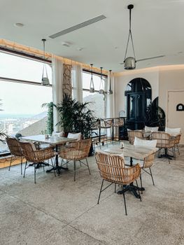 Elegantly designed cafe interior in Sharjah with a panoramic city view and modern decor.