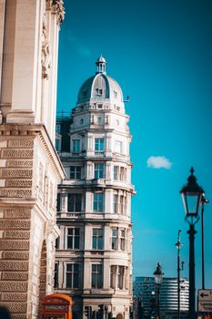 Elegant London skyline showcasing a historic architectural landmark with a classic dome under a vibrant blue sky.
