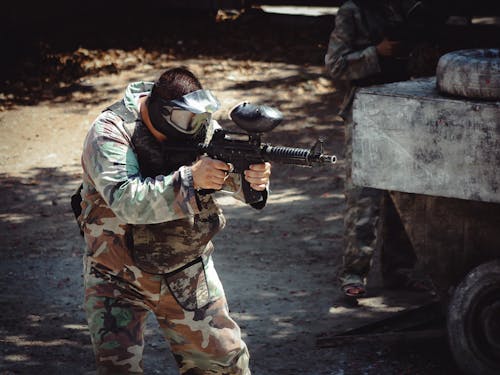 Man in Goggles Aiming with Machine Gun