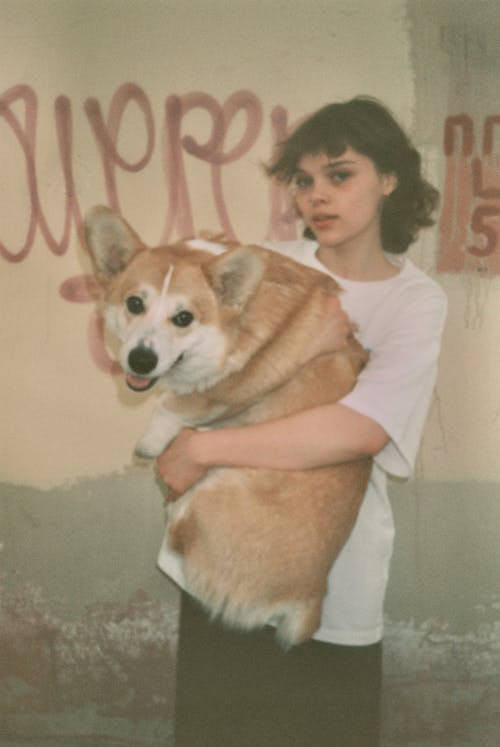 Woman in T-shirt Holding Dog