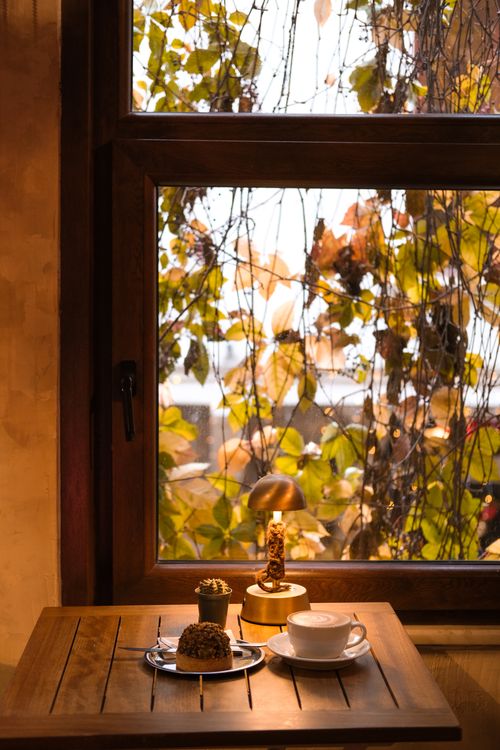 Free Warm autumn breakfast setting with coffee and cake by a window in Istanbul. Stock Photo