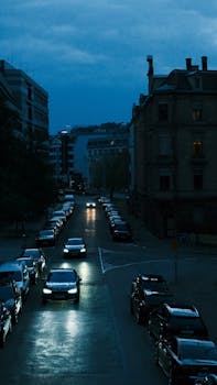 Night street scene in Stuttgart with city lights and cars, showcasing urban life.