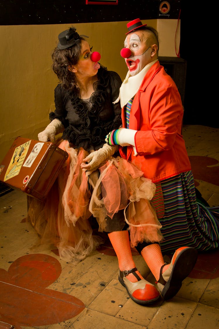 Woman And A Man Dressed As Clowns Making Faces