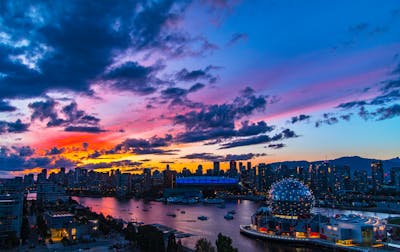 Downtown Vancouver is the city's bustling heart, encompassing vibrant neighborhoods like Yaletown, West End, and Coal Harbour. The image might showcase the sleek skyscrapers of Coal Harbour set against the backdrop of the shimmering Burrard Inlet and Stanley Park. Yaletown could be represented by its chic waterfront vibe, historic redbrick buildings, and trendy restaurants, while the West End offers a mix of modern condos and charming heritage homes nestled near lush parks and the famous English Bay beaches. Together, these areas create a dynamic urban core with a perfect balance of natural beauty, luxury living, and vibrant culture.