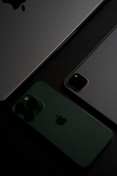 Close-up of a smartphone and tablet arranged on a dark surface, highlighting a sleek and modern design.