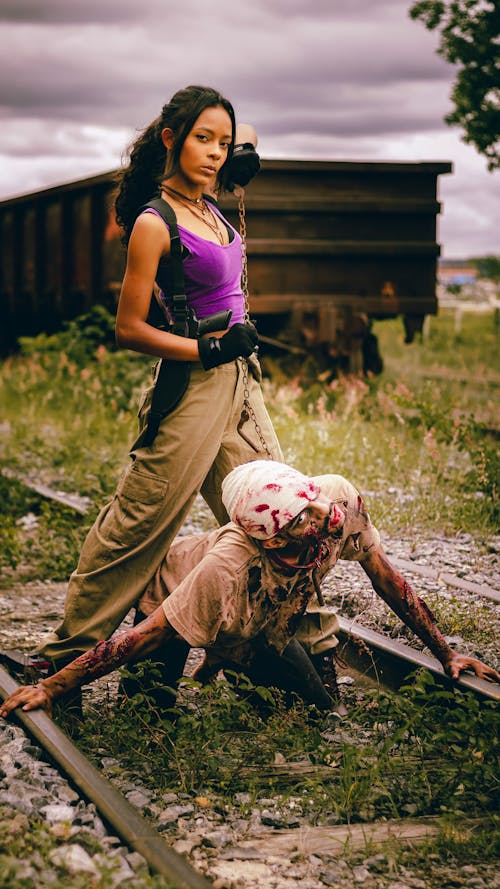 Woman Standing over Zombie