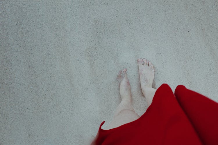 Barefoot Woman Standing On Sand