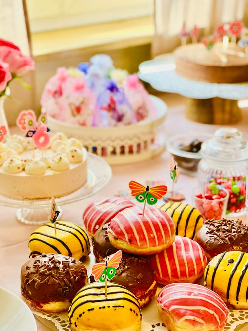 Free A vibrant dessert table showcasing decorated donuts, cakes, and sweets perfect for a festive gathering. Stock Photo