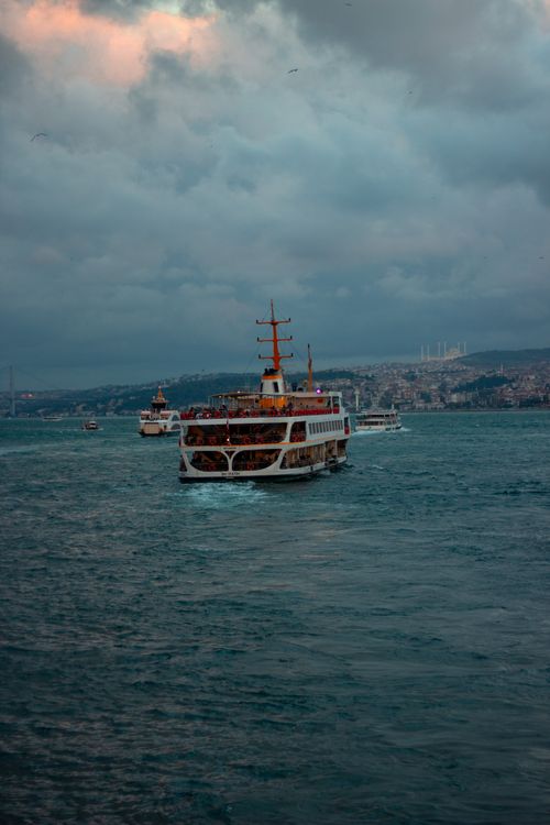 Free Ferry boat on the Bosphorus under a cloudy sky, showcasing Istanbul's unique water transportation. Stock Photo
