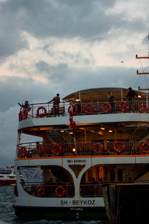 People Riding on a Ferry Boat Sailing on the Sea