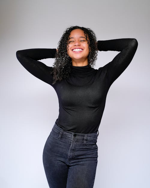 Woman with Curly Hair in Black Long Sleeves