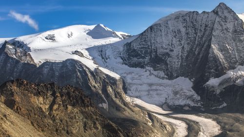 Free Stunning snow-covered Swiss Alps with rocky terrain under clear blue skies. Stock Photo