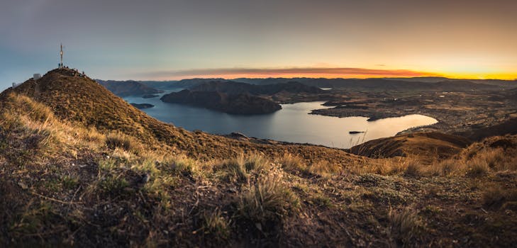 Beautiful panoramic view of Lake Wanaka from a hilltop at sunrise in New Zealand.