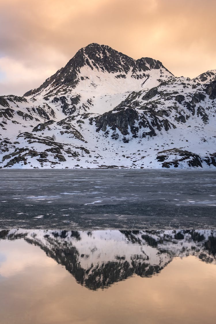 Mountain Behind Frozen Lake At Sunset