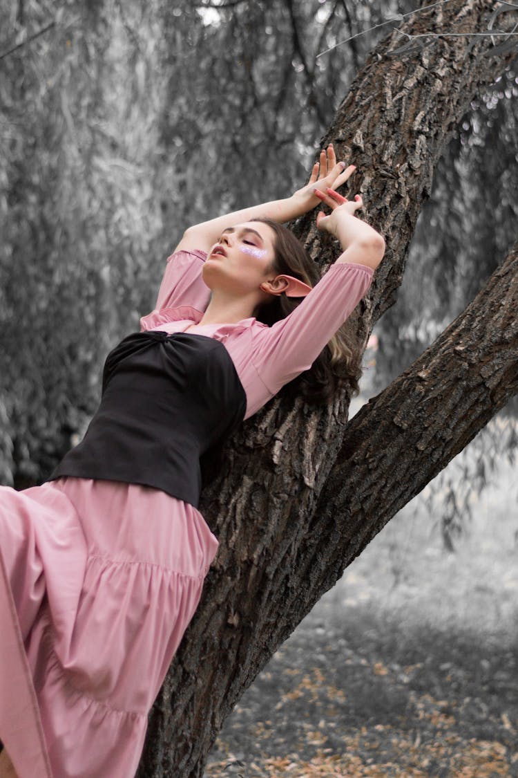 Woman In Elf Costume Leaning On Tree