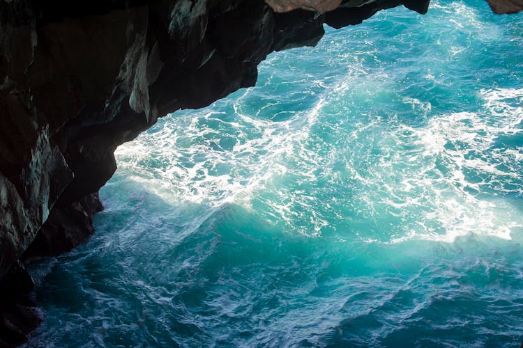 Sea Foam Floating On The Blue Sea 