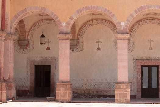 Architectural details of a colonnade in Santiago de Querétaro, Mexico highlighting vintage arches and columns.