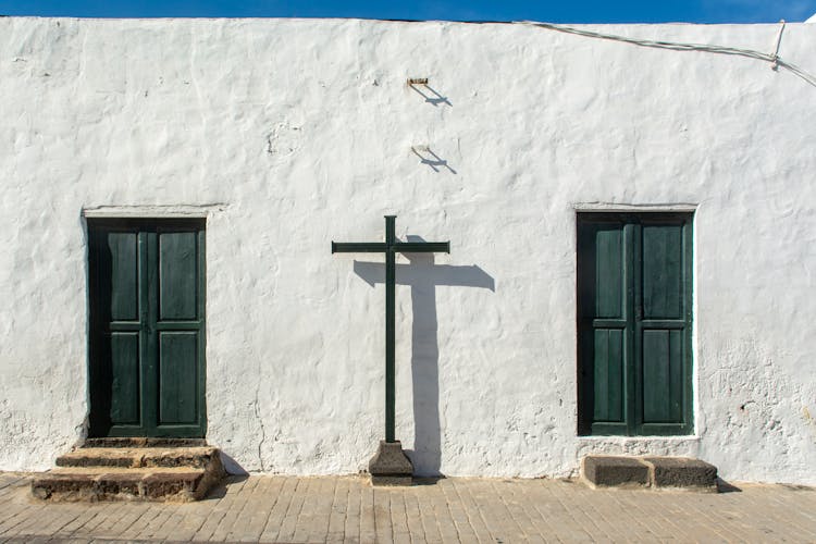 A Cross In Between The Wooden Doors 