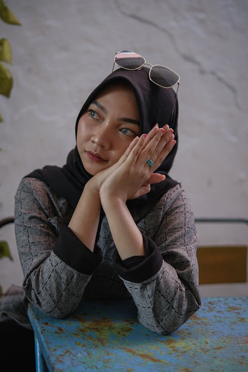 A Woman in Gray Long Sleeves Wearing Hijab with Sunglasses on Her Head