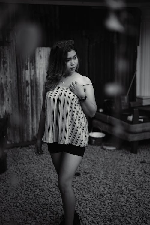 Grayscale Photo of Woman in Stripes Top and Shorts 