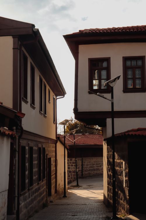 Free Explore the serene charm of a traditional alley in an old town setting with unique architectural details. Stock Photo