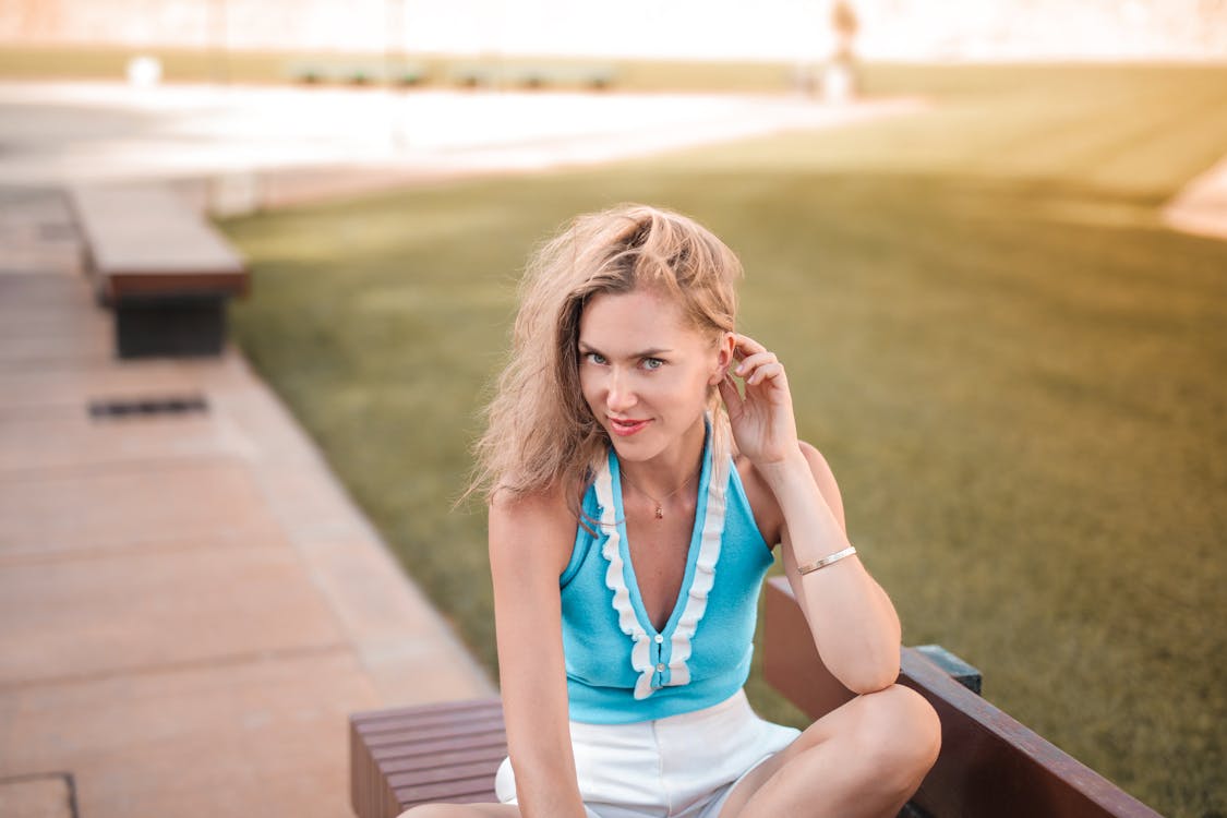 Woman in Blue Sleveless Shirt Sitting