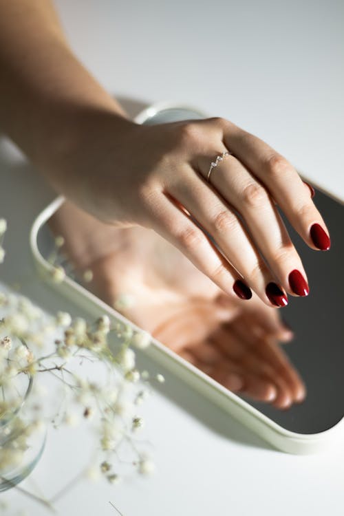 Woman Hand over Mirror