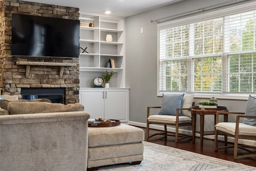 Free Cozy modern living room featuring stone fireplace and elegant furnishings. Stock Photo
