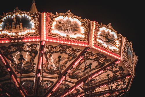 Free A beautifully illuminated vintage carousel with ornate decorations glowing in the night. Stock Photo