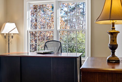 Books Lying on Desk by Window