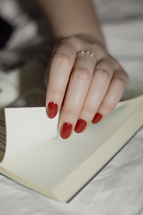 Red nails with gold glitter accent nail