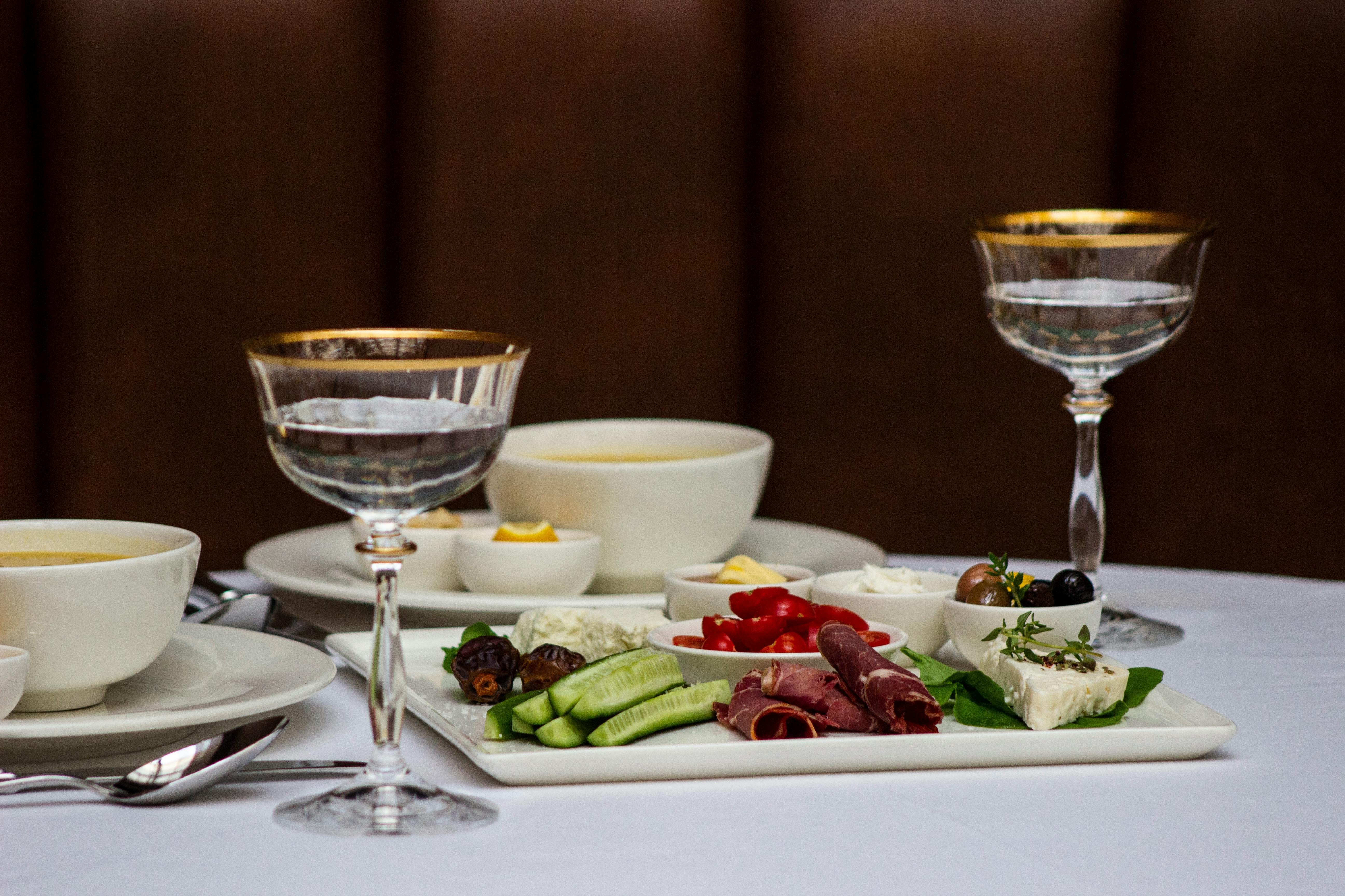 A luxurious table setting featuring gourmet appetizers, soups, and elegant glassware.